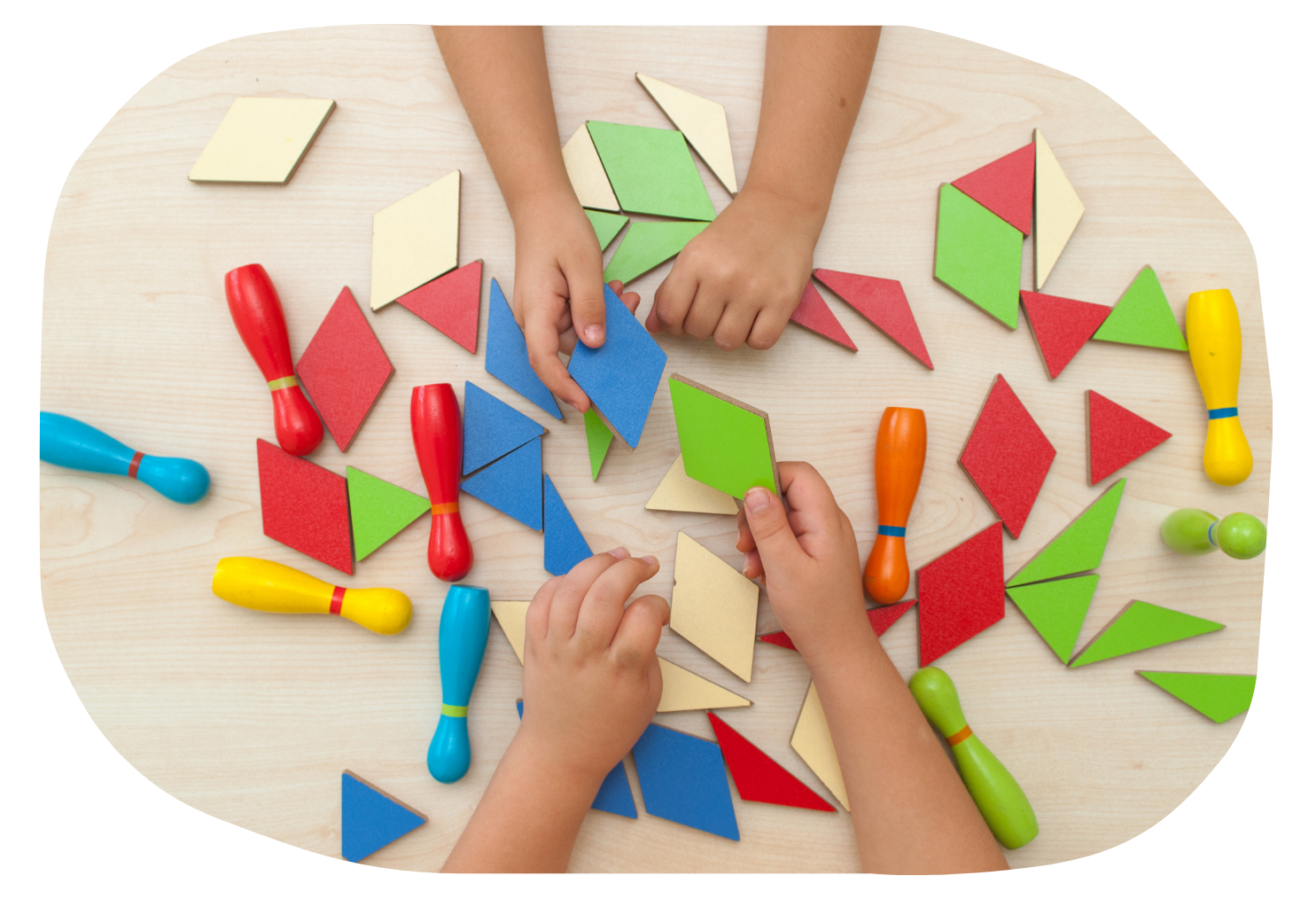 two sets of hands playing with tangram puzzle pieces